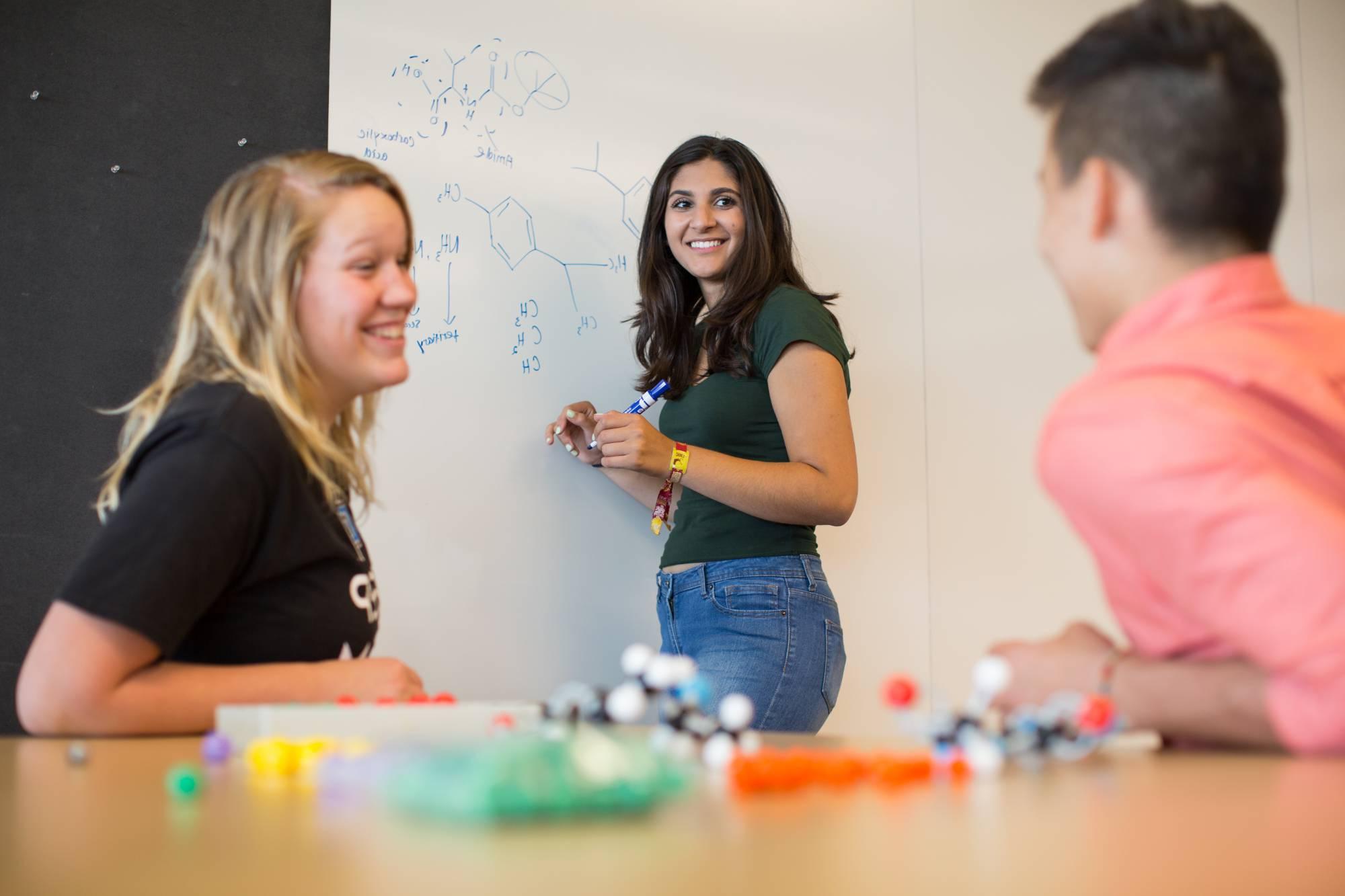 Girl smiling at whiteboard